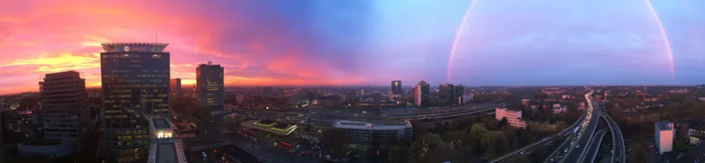 Essen Skyline bei Sonnenuntergang mit Regenbogen